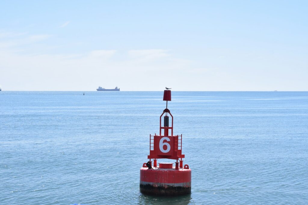 Red channel buoy with number off the coast
