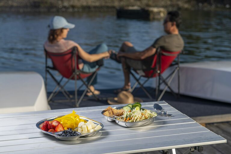 Crew having a meal on the deck of a sailing yacht