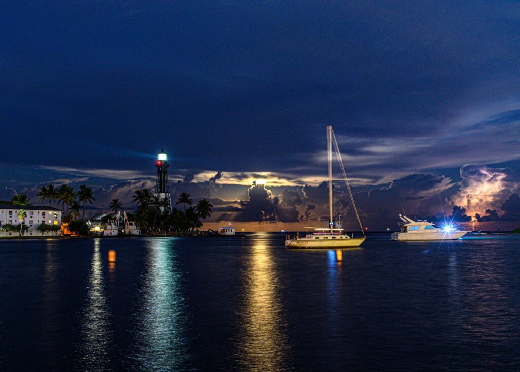 Sailing boat in harbour during a night-time thunderstorm