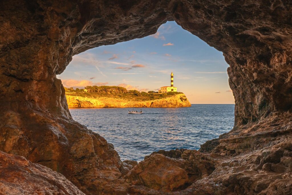 View from a rock cave of the lighthouse at Portocolom
